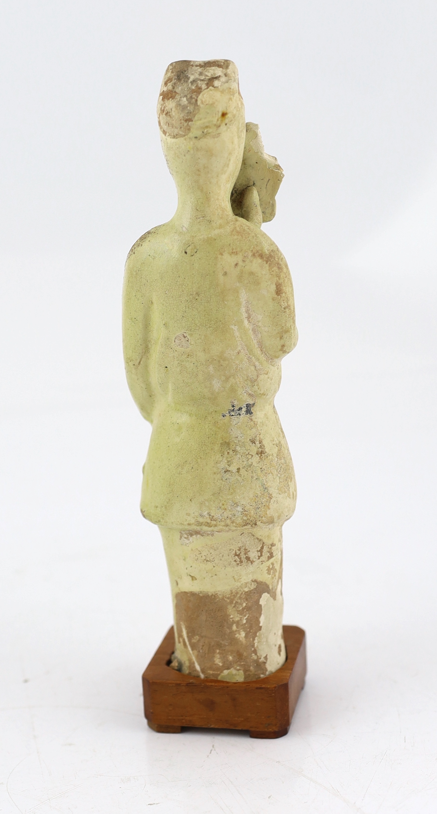 A Chinese pale green glazed pottery figure of an attendant, Tang dynasty (618-906 AD)